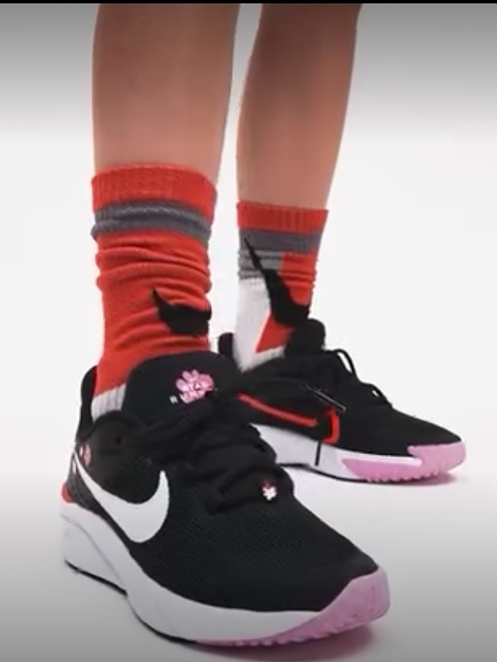 Nike Kids Black Sneakers with Pink Accents and White Swoosh